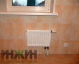 Радиатор отопления Kermi на стене с керамическим покрытием